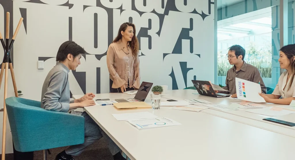 Team members collaborating in a modern office meeting.