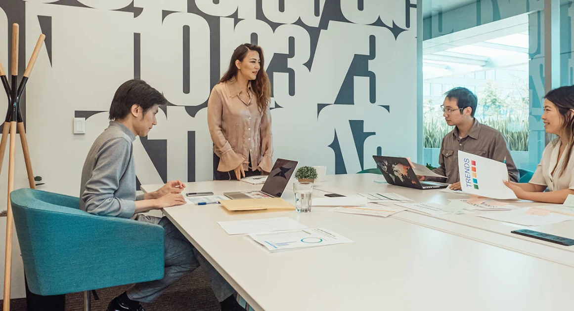 Team members collaborating in a modern office meeting.