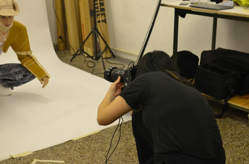Photographer taking pictures in a studio setup.