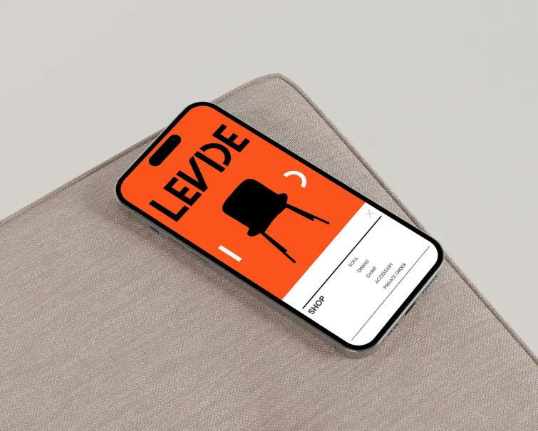 Smartphone displaying a bright orange sign with the word 'LEDVE' and a question mark.