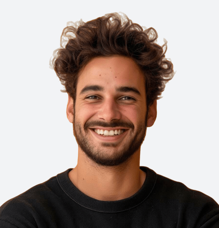 Smiling young man with curly hair and a beard in a black shirt.