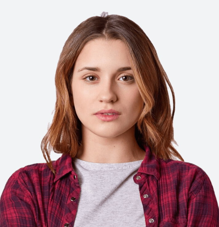 Portrait of a young woman with brown hair wearing a red plaid shirt.