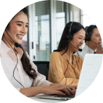 Customer service team assisting clients with headsets in a modern office.